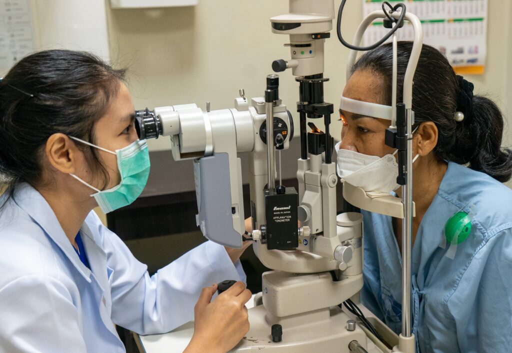 Doctor performing eye test on patient in hospital